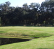 The par-5 ninth hole on the Hills Course at Palmetto Dunes Resort features water in front of the green.